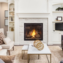 Fireplace with a nice fire in a nicely decorated livingroom